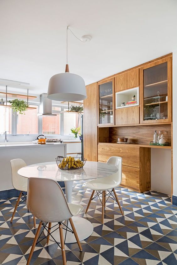 open kitchen, patterned floor tiles, white tulip table, white modern chairs, white pendant, white kitchen table, wooden built in cupboard