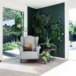 Green Corner With Floating Plants, Wooden Floor, White Wall, Grey Chair, Wooden Round Side Table