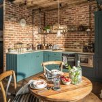 Kitchen, Wooden Floor, Brick Wall, Green Wooden Cabinet, Wooden Ceiling, Pendant, White Kitchen Top, Wooden Round Dining Table, Wooden Chairs