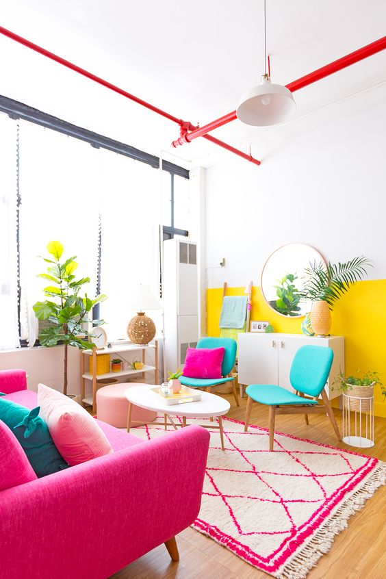 living room, wooden floor, white pink patterned, white wall, red pipe, yellow white wall, turquoise chair, white coffee table, shocking pink sofa