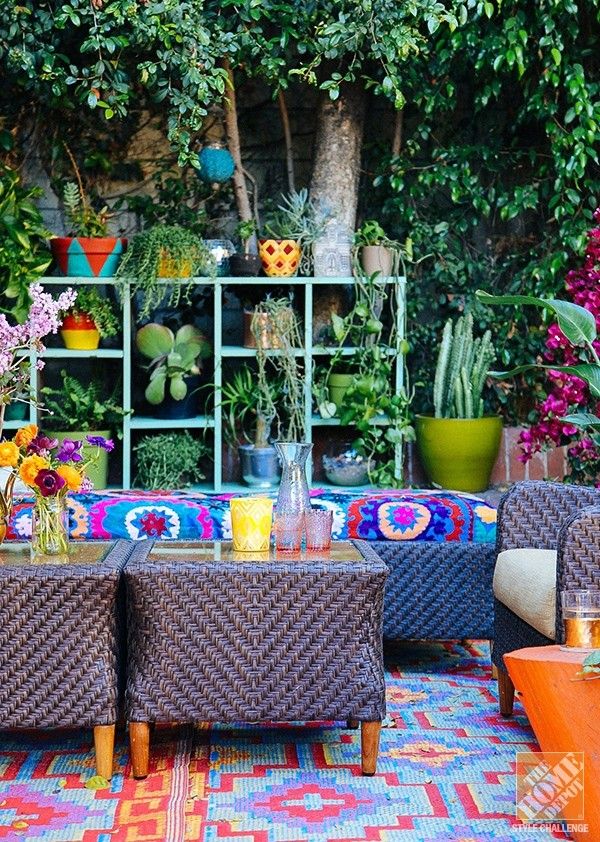 patio, colorful patterned rug, purple rattan bench with colorful pattern, purple rattan chair, purple rattan tables with glass top, orange wooden slab