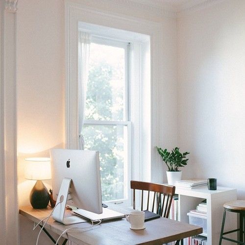 small study, wooden table, wooden chair, white wall, white low shelves