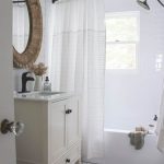 Bathroom, White Floor Tiles, White Wall Tiles, White Cabinet Vanity, White Counter Top, White Toilet, Round Rattan Framed Mirror
