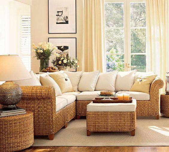 brown woven rattan corner sofa, woven rattan round coffee table, white cushion, cream rug, wooden floor, white wall, white crutain