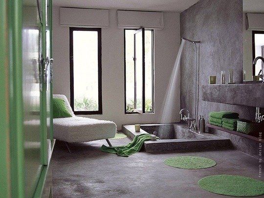 bathroom, grey floor, grey wall, glass window, indented tub on the floor, white lounge chair, green rug