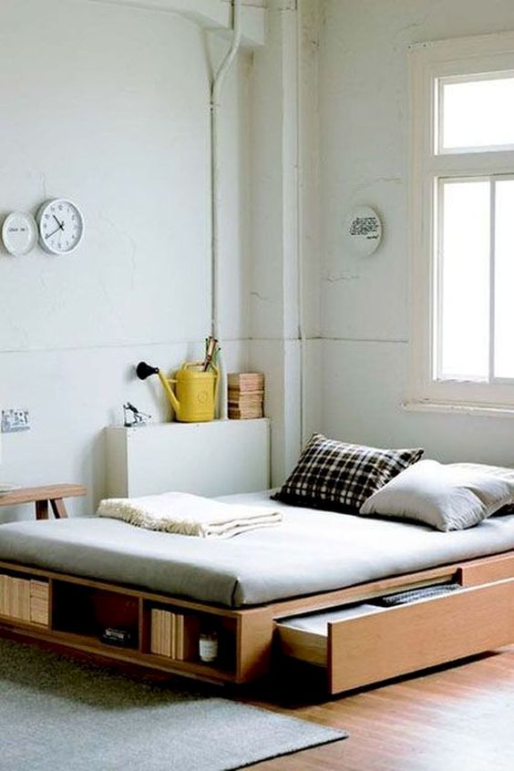 bed platform, wooden material, shelves, drawers, white wall, wooden floor, grey rug