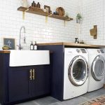 Laundry Room, Black Cabinet, White Apron Sink, White Machines, White Subway Wall Tiles, Floating Shelves, Grey Floor, Patterned Rug