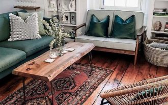 living room, wooden floor, white wall, green sofa, wooden sofa with light green cushion, wooden coffee table, rattan chair, white shelves