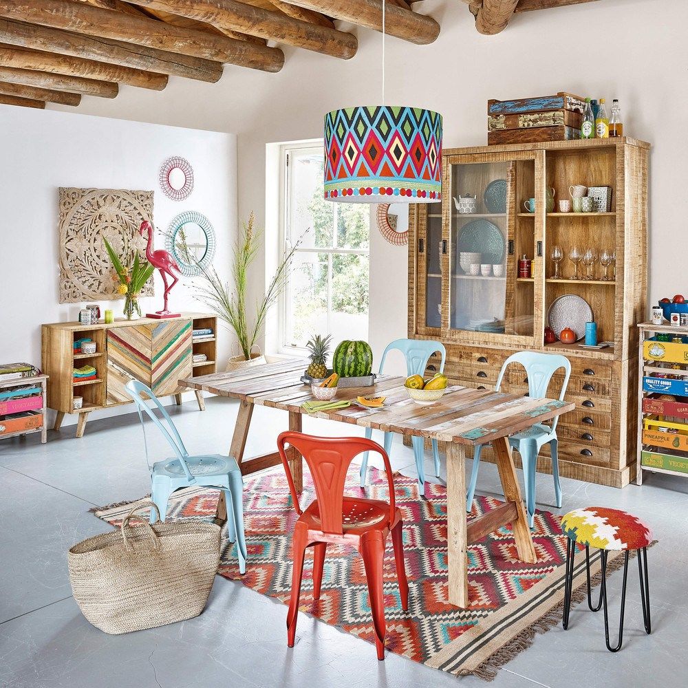 dining room, grey floor tiles, white wall, wooden beams, wooden table, patterned rug, blue red chairs, patterned pendant, wooden cabinet, colorful cabinet