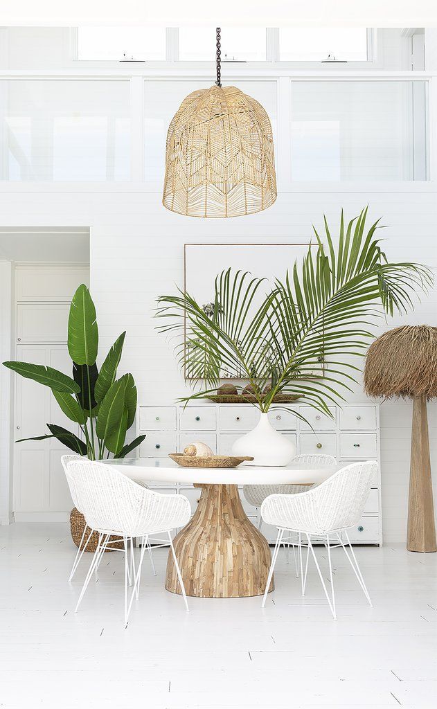dining room, white marble floor, white plank wall, rattan pendant, white round table, white rattan chairs, white wooden cabinet