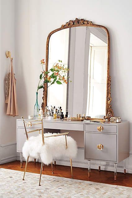 golden large framed mirror, on the grey wooden make up table, wooden floor, golden lined chair