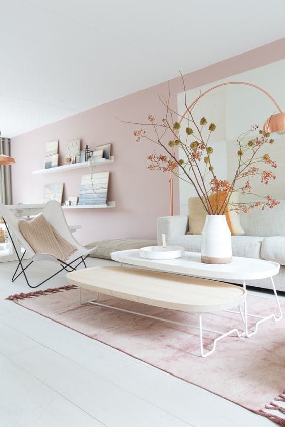 living room, white wooden floor, pink wall, white and wooden coffee table, white butterfly chair, white sofa, pink wall