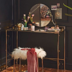 Make Up Station, Wooden Floor, Black Wall, Wainscoting, Golden Table With Glass Top, Golden Stool With White Fur, Round Mirror