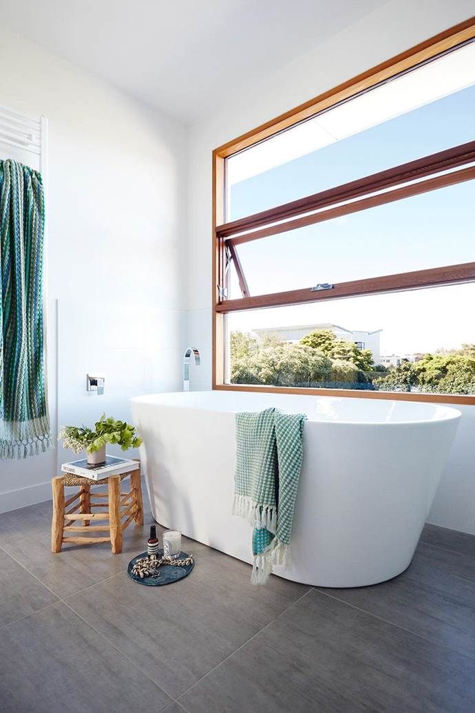 bathroom, grey floor tiles, white wall, white tub, glass window