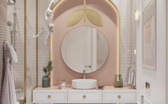 bathroom vanity, white wall, white tiny wall tiles, pink accent wall in curvy indented nook, LED lights, golden accents, round mirror, white floating vanity, white round sink