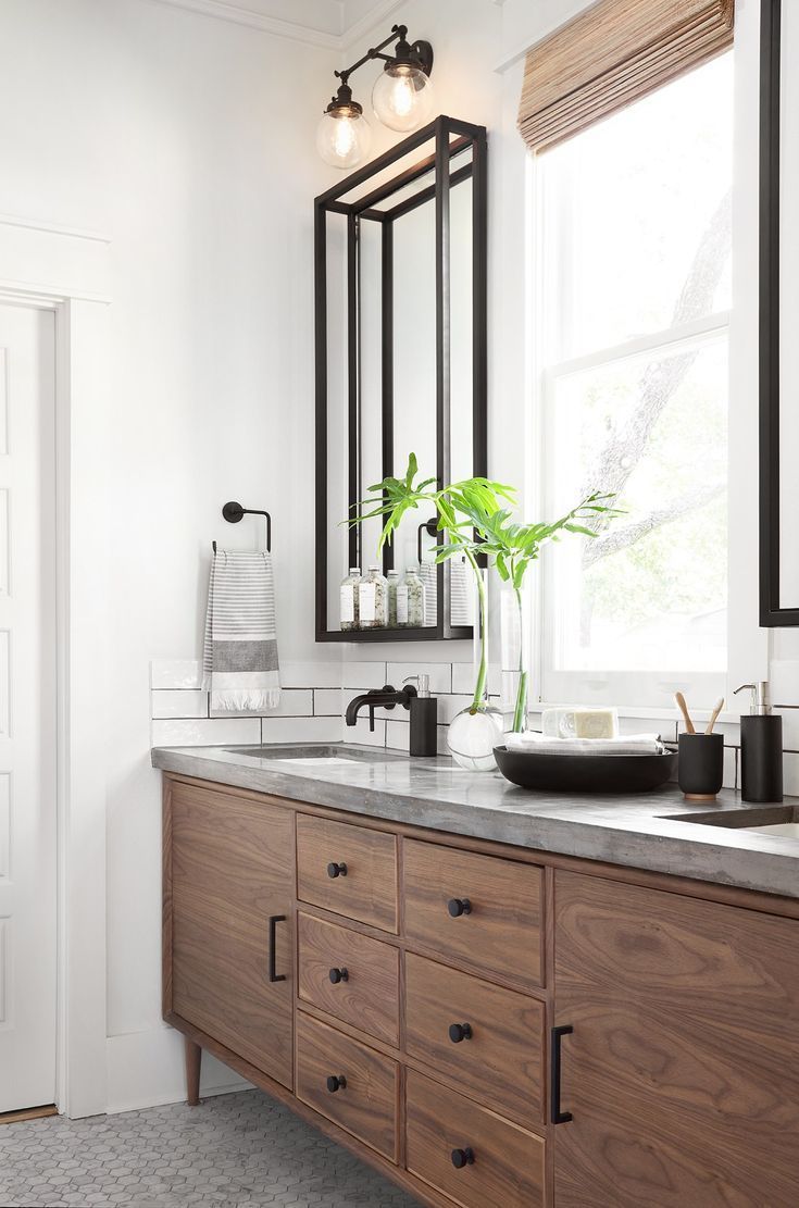 bathroom, white wall, wooden cabinet, marble top, black iron mirror with shelves, glass bulb adjointed sconces