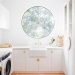 Laundry Room, Orange Patterned Floor, White Wall, White Cabinet, White Apron Sink, Round Glass Window, White Cabinet