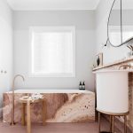 Bathroom, White Round Sink Vanity, Golden Stool, Pink Marble Tub, White Wall, Round Mirror, Pink Marble Shelves