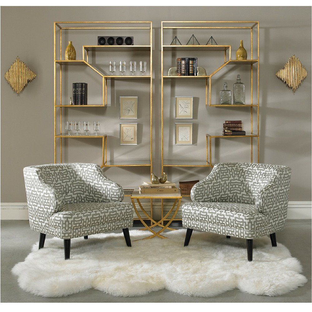 patterned chairs, golden side table, grey wall, golden framed shelves