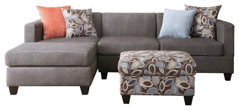 grey sectional sofa with chic pillows and floral print ottoman
