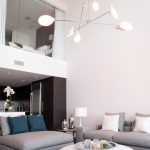 modern house interior sofa lamp modern table pillow flower white wall white ceiling unique hanging lamps