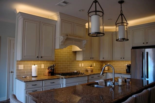 white wooden traditional kitchen with LED lcabinte lighting above and under the cabinet