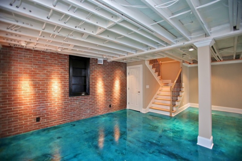 nicely designed basement floors concrete floor brick wall stairs pillars window door lighting