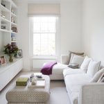 seating in living room with white corner sofa and brown ottoman for coffee table