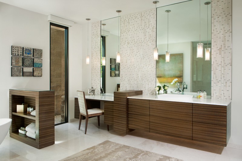 white countertop vanity with zebra cabinet, mosaic tile on the wall, long glass pendants, clear makeup area with white chair