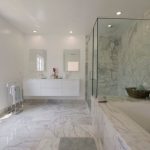 carrera marble bathrooms ceiling lights undermount cabinets alcove shower built in tub glass doors white tiles standing towel rack contemporary design