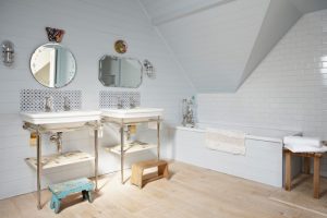 pedestal sink with backsplash mirrors stools shelves lamp bathtub towel shabby chic style