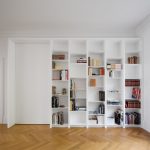 Modern Home Library Idea White Bookshelves Inserted In Wall Medium Toned Wood Floors