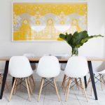 Trendy And Small Dining Room White Walls White Porcelain Floors Wood Dining Table Without Finishing Modern White Dining Chairs With Wood Legs Bright Yellow Wall Art