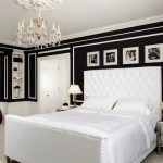 black and white bedroom chandelier white bed with white tufted headboard elegant nightstands black wall white ceiling fireplace