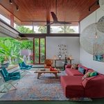 Living Room With Ret Sofa, Wooden Coffee Table, Blue Soft Cuhioned Chairs, Wooden Chairs With Red Orange Cushion