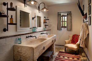 Mediterranean beige tile bathroom with an integrated sink accent curtain and rug concrete sink fixed lamp bathroom tile floors double rectangular mirrors