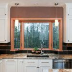 Black Tiled Backsplash Bay Window Beige Trim Granite Countertop Pendant Lights White Cabinet Sink Stainless Steel Appliances