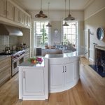 Curved Kitchen Island Granite Worktops Hand Painted Cabinet Dishwasher Oak Flooring Pendant Lights Sink Fireplace