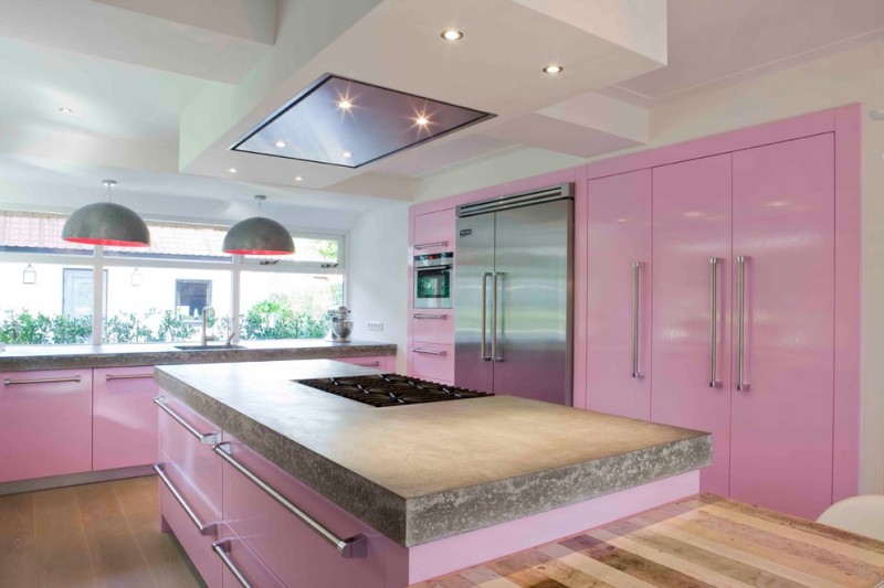 pastel kitchen pink cabinets stainless hardware wood flooring modern hood wood countertops glass windows recessed lighting