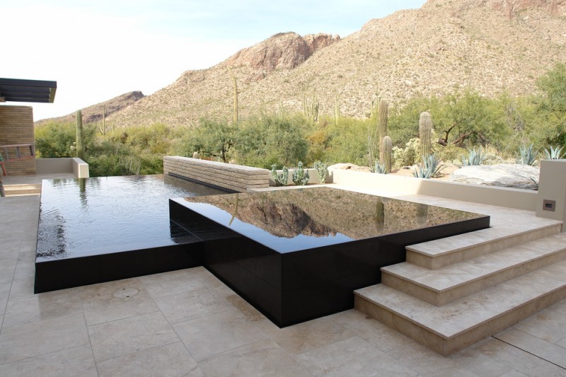 raised pool raised spa black granite beige granite paver tiled floor pool concrete bench hill cactus