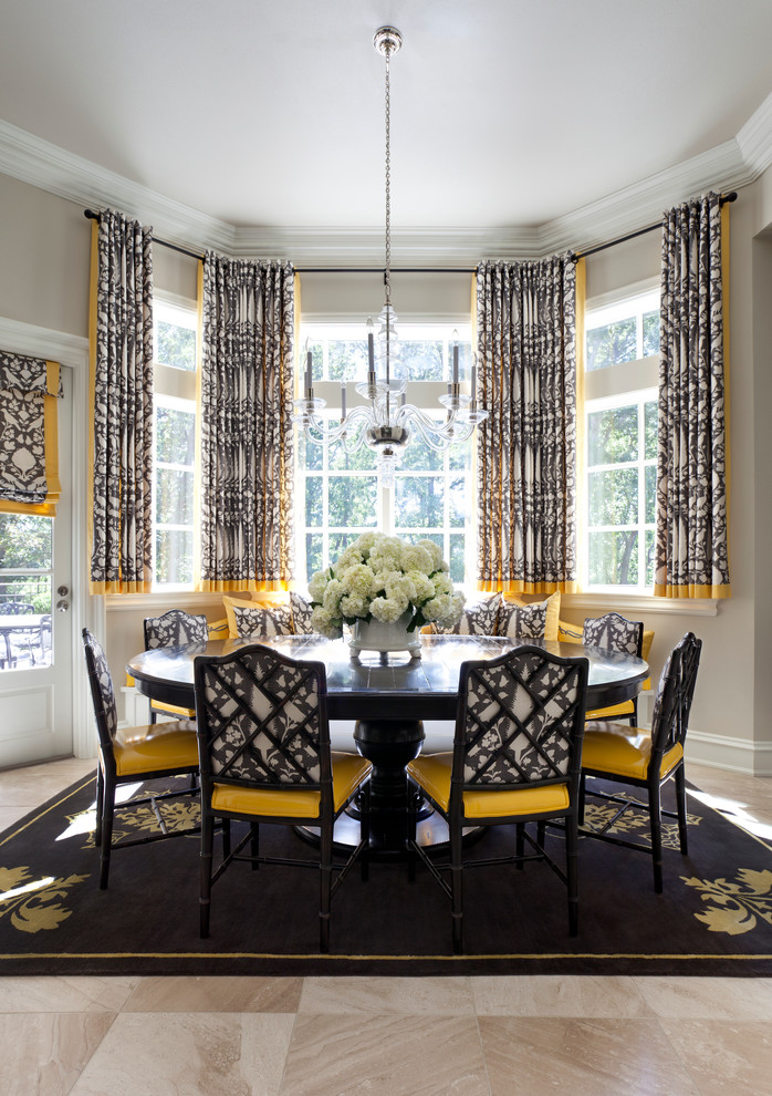 black dining table pedestal table black area rug black chairs yellow patterned curtains glass windows glass doors colorful patterned curtains shade