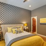 Grey Yellow Bedroom Grey Patterned Wall Artwork Wooden Floor Yellow Rug Beige Headboard Yellow And Grey Bedding Pillows Table Lamps Mirrored Nightstands