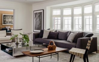 rustic modern coffee table mirrored coffee table grey sofa grey and white throw pillows white windows chair white striped armchairs area rug artwork