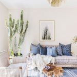 Living Room With White Wall, White Bench, White Sofa, Woden Coffee Table, Plants, White Blue Rug