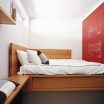 Underbed Storage Solutions White Bedding White Pillows Red Accent Walls Brown Carpet Wall Mounted Wooden Shelves Window