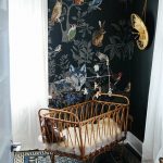 Rattan Baby Cot In A Nursery With Animals Wallpaper, Blue Rug, White Curtain