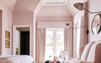 bedroom, brown rug, pink bed, pnk chairs, blue top coffee table, pink wall, pink curtain, white patterned ceiling