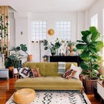 Living Room With Wooden Floor, White Rug, Green Sofa, Plants, Piano