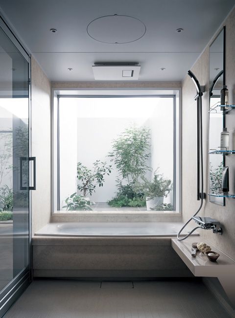 bathroom, white floor, white rug, white wall, white tub, shower, floating shelves, mirror, large square windows