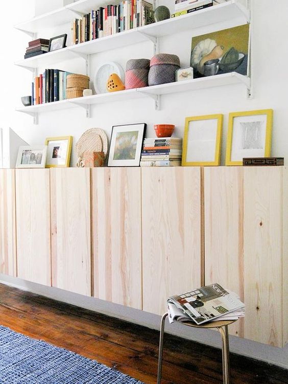 plain wooden floating cabinet with white floating shelves, white walls, wooden floor
